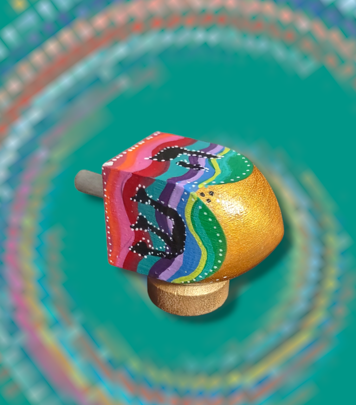 Hand-painted swirly colorful dreidel.